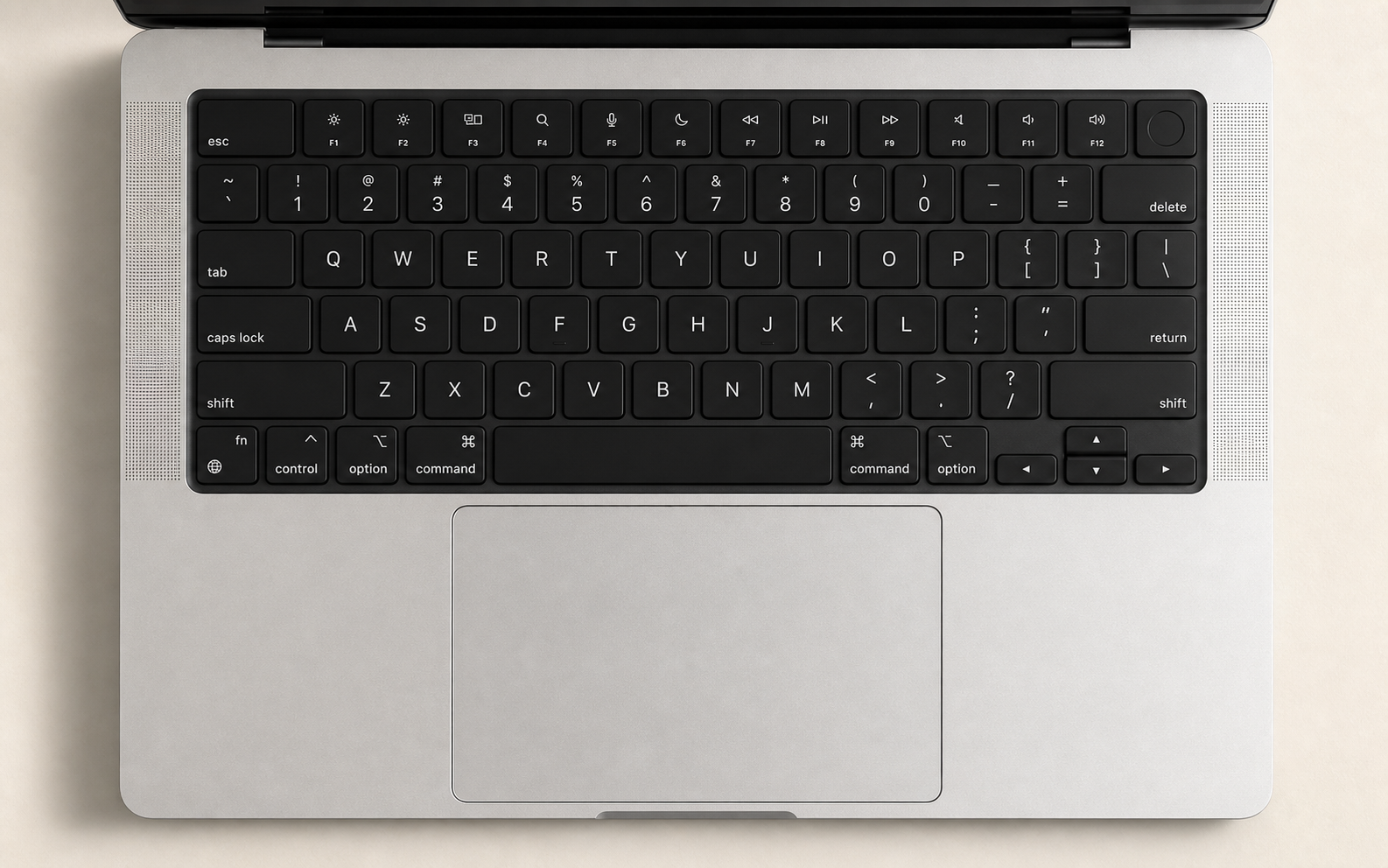 Top-down photorealistic silver MacBook Pro with black keyboard and large trackpad